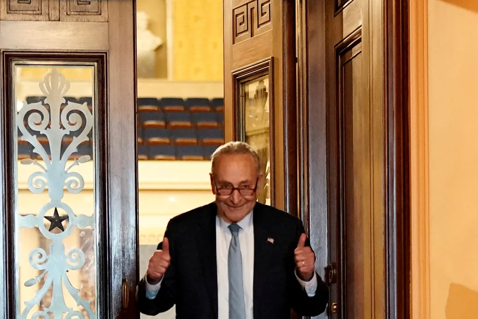 Victory: US Senate Majority Leader Chuck Schumer, a New York Domocrat, gestures after the Inflation Reduction Act of 2022 passed on a party line vote