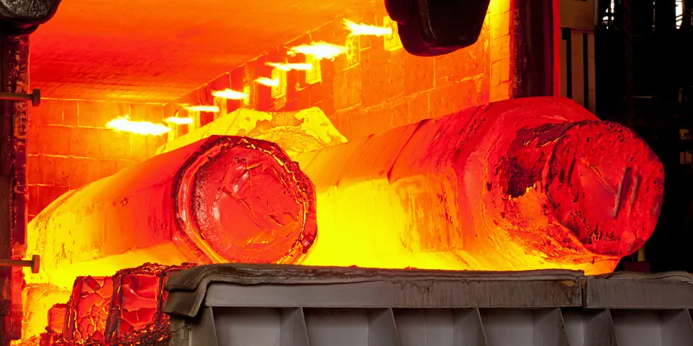 Two hot molten forged steel rods in a furnace.
