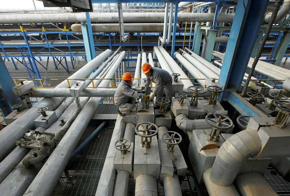 On tap: workers at a refinery in China