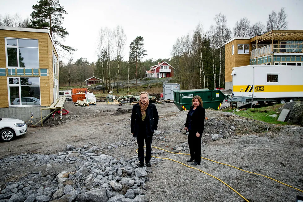 Arkitekt Rune Breili har tegnet mange av hyttene på Tjøme som det er blitt byggesaker av. Her med advokat Vibeke Hein Bæra på tomten til Dalsveien 57, et prosjekt som er stoppet. Byggingen på de to nabotomtene i bakgrunnen er ikke stanset. Foto: Gorm K. Gaare