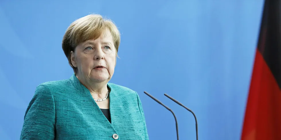 Old and new German Chancellor Angela Merkel.
