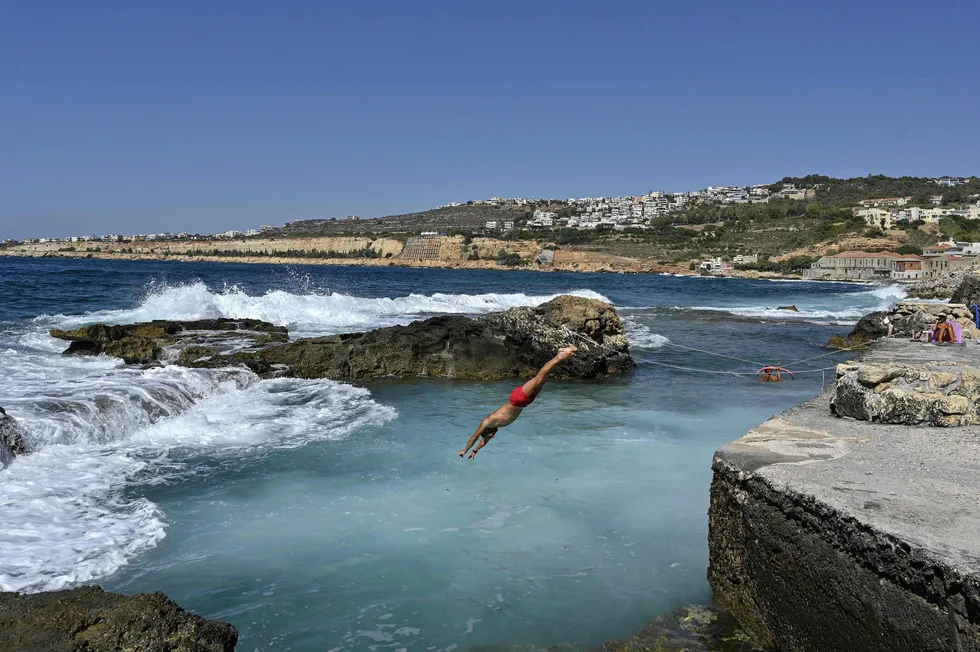 ExxonMobil makes move: a man dives into a natural pool offshore Chania on the Greek island of Crete
