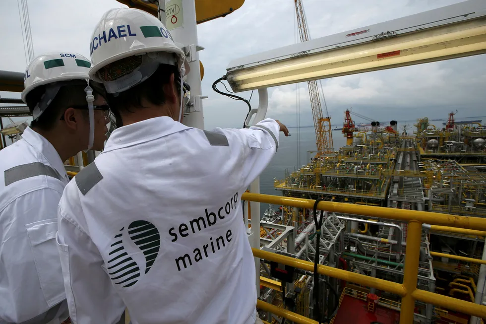 Busier times: Sembcorp Marine workers surveying their task in Singapore
