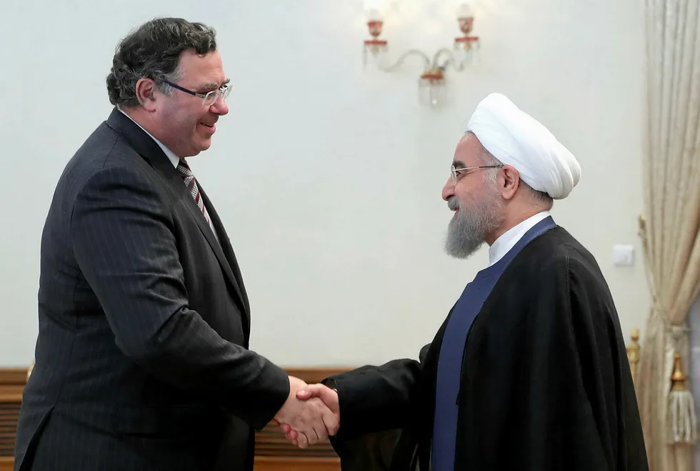 Landmark: Iranian President Hassan Rouhani shakes hands with Total chief executive Patrick Pouyanne