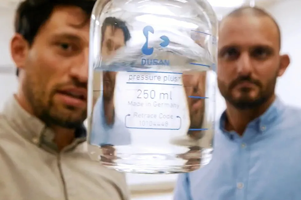 HySiLabs co-founders Vincent Lome and Pierre-Emmanual Casanova examine a sample of their liquid carrier solution.