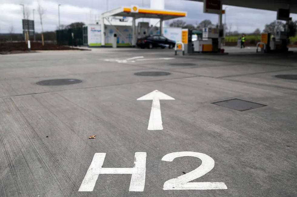 An H2 sign, painted on the forecourt, directs vehicles towards a Shell hydrogen pump in Cobham, England, which has since been closed down.