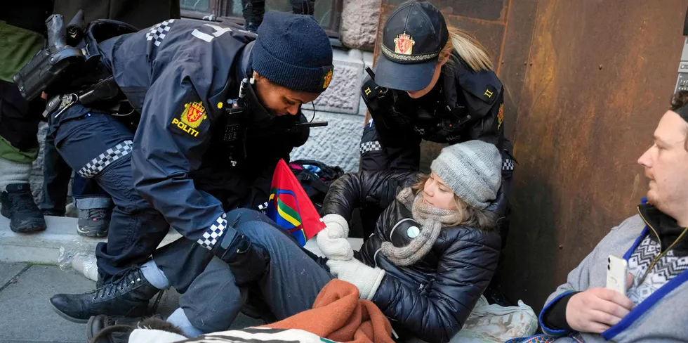 Climate activist Greta Thunberg being detained by Norwegian police.