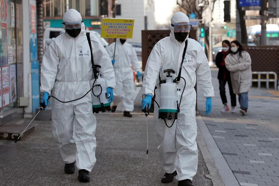 Taking no chances: South Korean soldiers on 6 March disinfecting a street in the capital Seoul