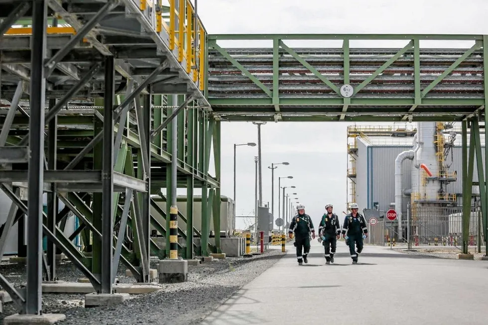 No entry: workers walking past processing facilities on the Tengiz oilfield in Kazakhstan, operated by Chevron-led Tengizchevroil