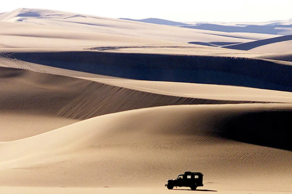 Exploration campaign: a four-wheel-drive vehicle crosses the sand dunes near Egypt's Western Desert oasis of Siwa