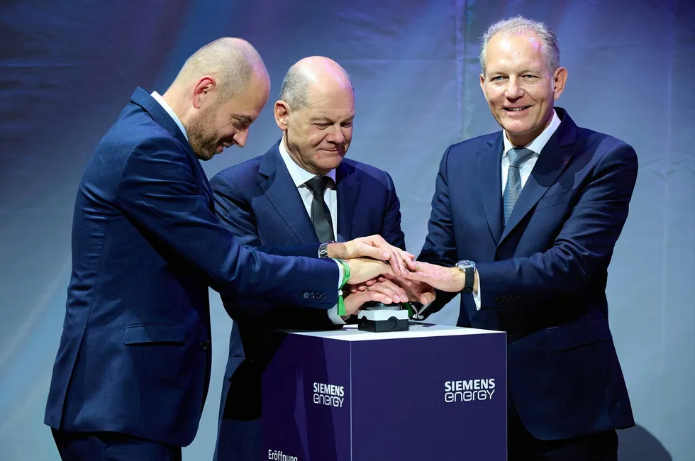 Siemens Energy CEO Christian Bruch (left), German Chancellor Olaf Scholz (centre), and Air Liquide CEO Francois Jackow (right) press the button to officially launch the electrolyser gigafactory.