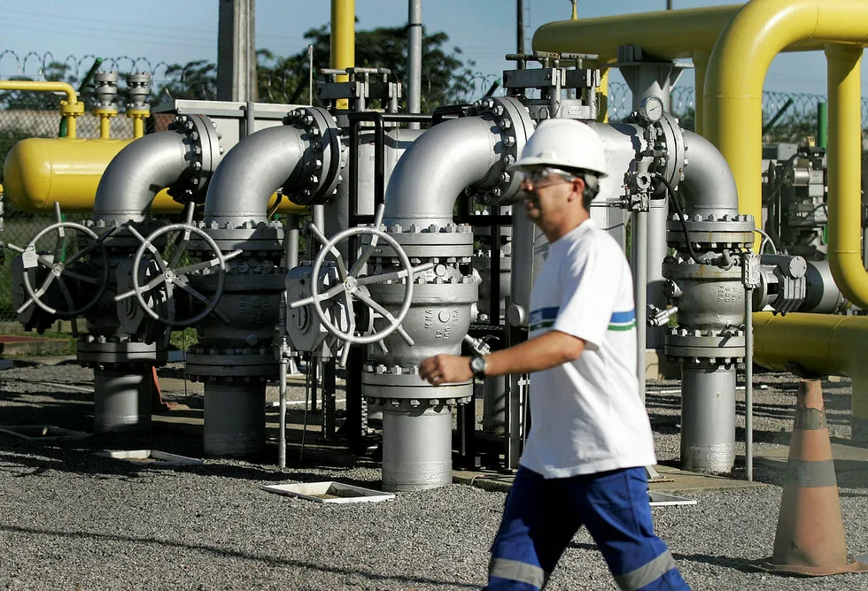 Sale: a Brazilian worker walks past a natural gas regulating station called a city gate by its Brazilian owner Comgas