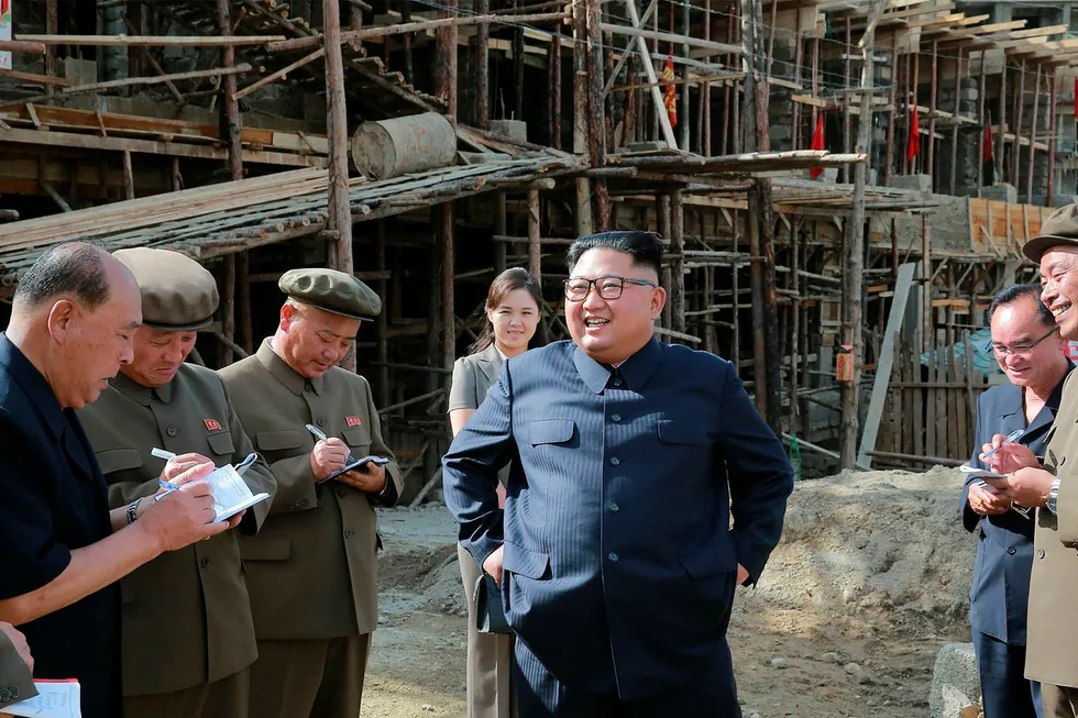 TOPSHOT - This undated picture released by North Korea's official Korean Central News Agency (KCNA) on August 19, 2018 via KNS shows North Korean leader Kim Jong Un (C) inspecting construction sites in Samjiyon County, Ryanggang Province with his wife Ri Sol Ju (C-behind). (Photo by KCNA VIA KNS / KCNA VIA KNS / AFP) / - South Korea OUT / REPUBLIC OF KOREA OUT ---EDITORS NOTE--- RESTRICTED TO EDITORIAL USE - MANDATORY CREDIT "AFP PHOTO/KCNA VIA KNS" - NO MARKETING NO ADVERTISING CAMPAIGNS - DISTRIBUTED AS A SERVICE TO CLIENTS THIS PICTURE WAS MADE AVAILABLE BY A THIRD PARTY. AFP CAN NOT INDEPENDENTLY VERIFY THE AUTHENTICITY, LOCATION, DATE AND CONTENT OF THIS IMAGE. / ---