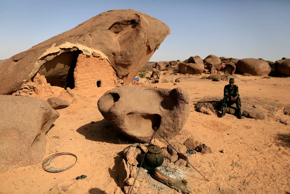 Tense: Polisario fighter sits on a rock at a forward base on the outskirts of Tifariti, Western Sahara