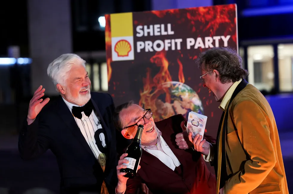 Greenpeace protestors stage a mock boardroom party outside Shell headquarters.