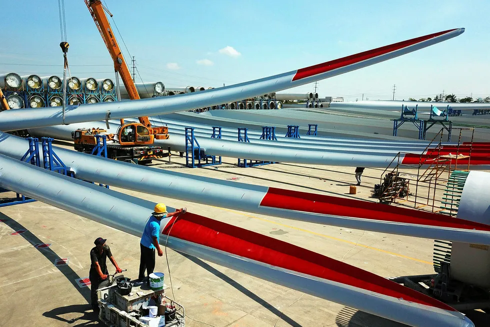 Blade runners: workers check the quality of newly-manufactured wind turbine blades at a factory in China's eastern Jiangsu province
