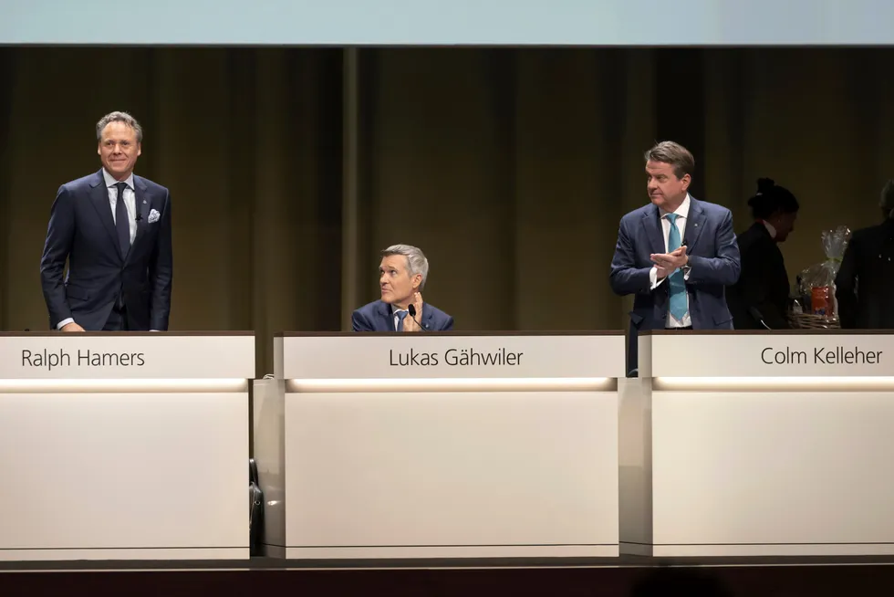 Fra venstre: Avtroppende toppsjef Ralph Hamers får applaus fra visestyreleder Lukas Gähwiler (i midten) og styreleder Colm Kelleher (til høyre).