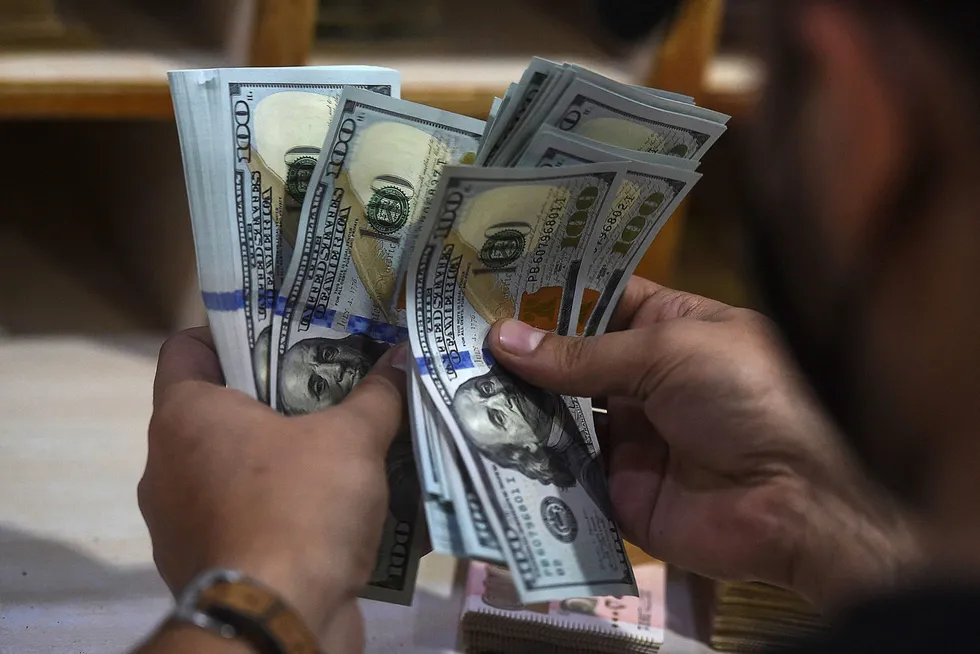 Cash is king: a foreign currency dealer counts US dollars at a shop in Karachi, Pakistan