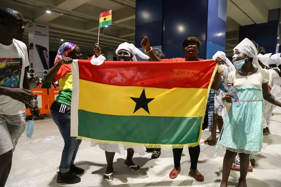 Seeking partner: supporters of Ghanaian Olympic bronze medal boxer Samuel Takyi hold the country's flag at Accra airport