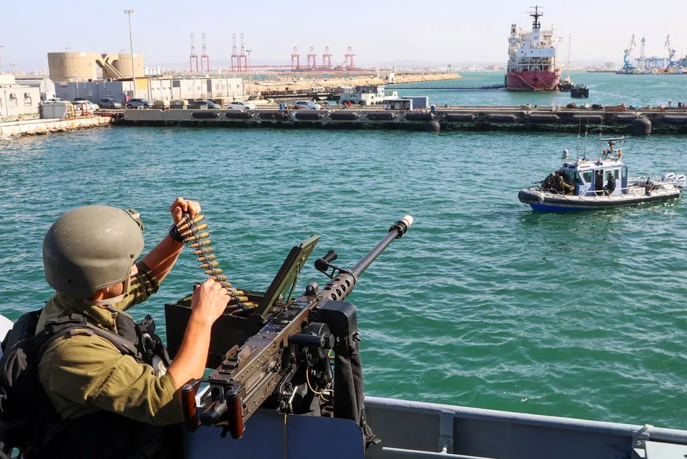 Patrols: An Israeli sailor manning a machine gun aboard a Sa'ar 4.5-class missile boat in Haifa as it prepare to depart for patrol duties offshore Gaza in November 2023.