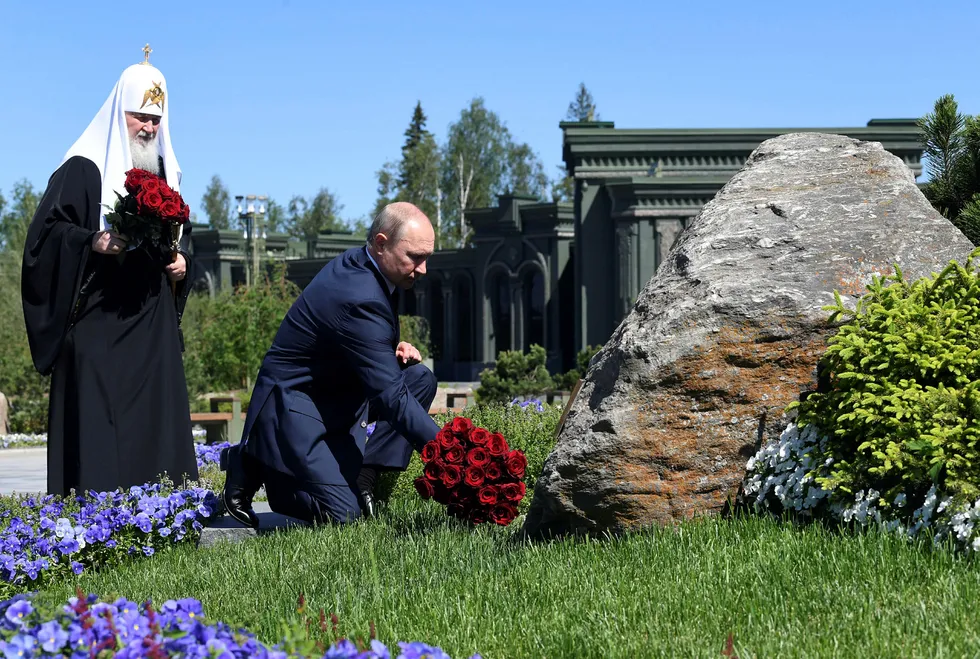 Term move: Russia's President Vladimir Putin (right) lays flowers at a monument near the Resurrection of Christ Cathedral near Moscow on 22 June