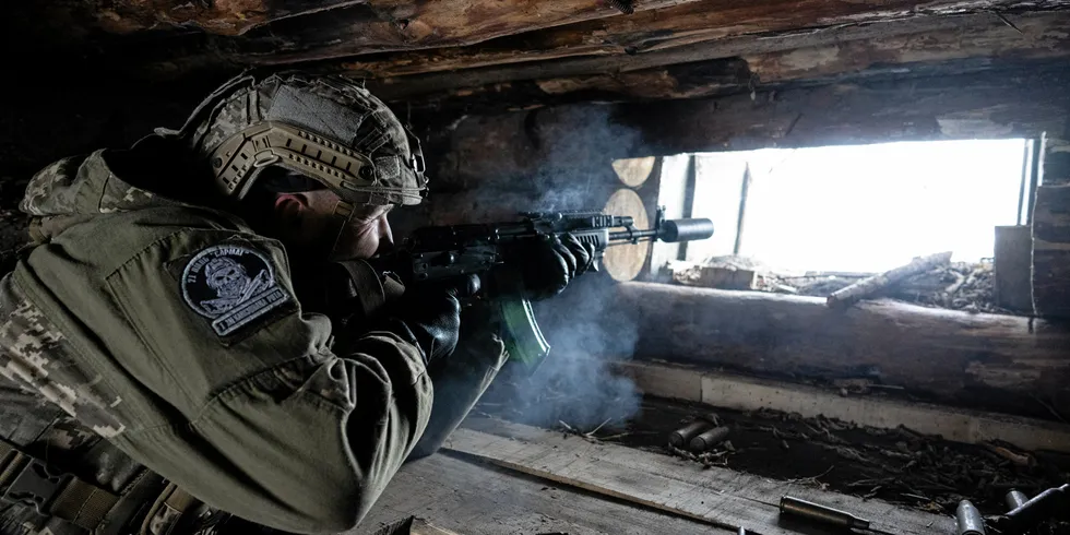 A Ukrainian soldier fires his weapon during shooting practice at a trench outside of Donetsk.