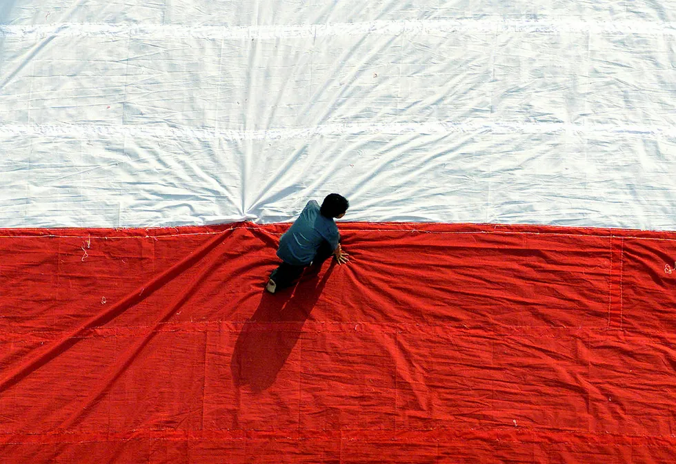 Processing: an Indonesian man prepares a giant national flag in Surabaya, East Java