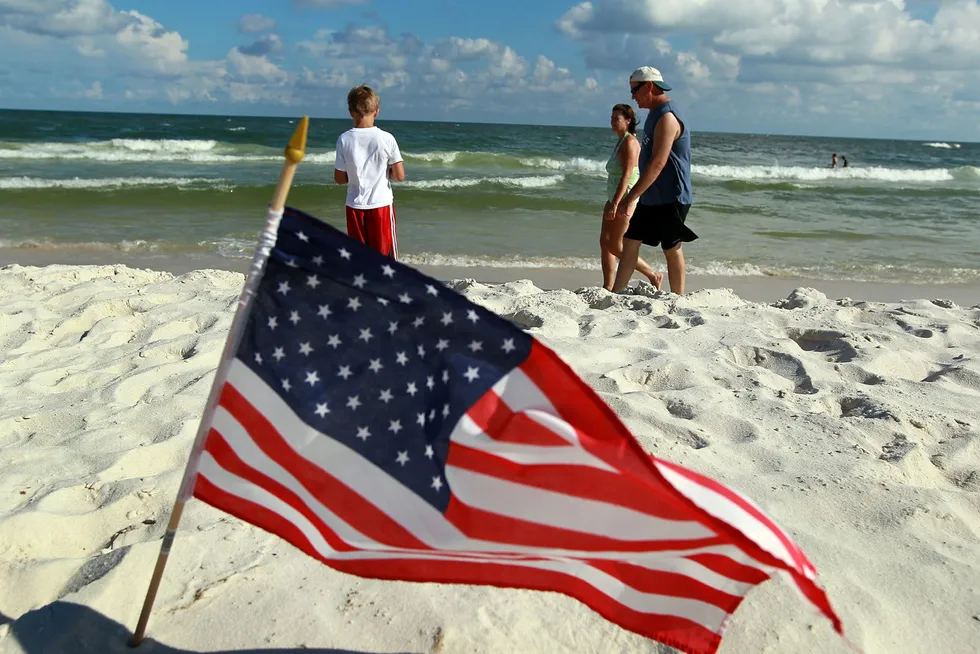 Resource boost: a US flag flutters in the sea breeze at a beach on Alabama's Gulf of Mexico coast