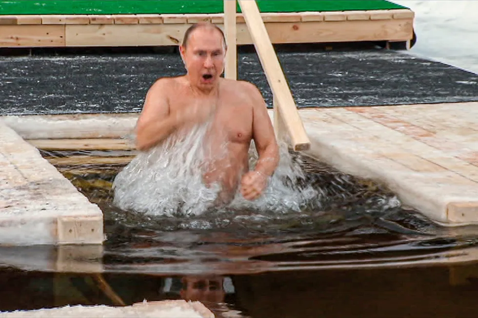 Awakening: Russian President Vladimir Putin crosses himself while bathing in the icy water during a traditional Epiphany celebration in Russia in January 2021