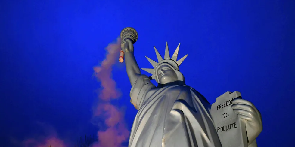 A replica of the Statue of Liberty emitting smoke created by Danish artist Jens Galschiot, displayed at the Rheinaue park during COP23.