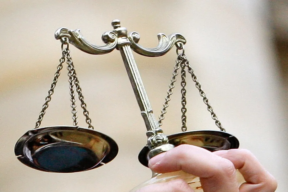 Guilty plea: a lawyer holds the scales of justice.