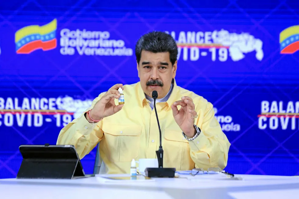 The cure: Venezuelan President Nicolas Maduro holding a bottle of the Carvativir medicine