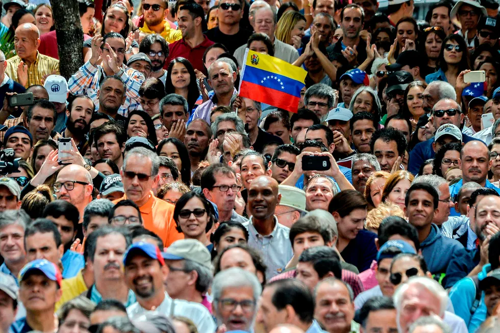 Venezuela: opposition supporters listen to nation's self-proclaimed acting president Juan Guaido