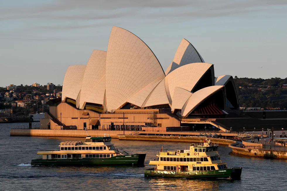Covid complexities: empty ferries pass in front of the Sydney Opera House on 14 August 2021