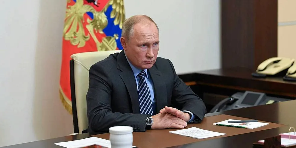 Russia’s President Vladimir Putin is seen in his office in the Novo Ogaryovo residence during a video-conference meeting with Russian government officials.