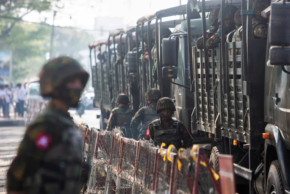 Trouble spot: soldiers stand next to military vehicles in Yangon, Myanmar