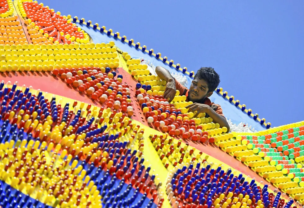 Powering up: a worker adjusts lightbulbs on a pandal in Colombo for the Buddhists' Vesak celebrations
