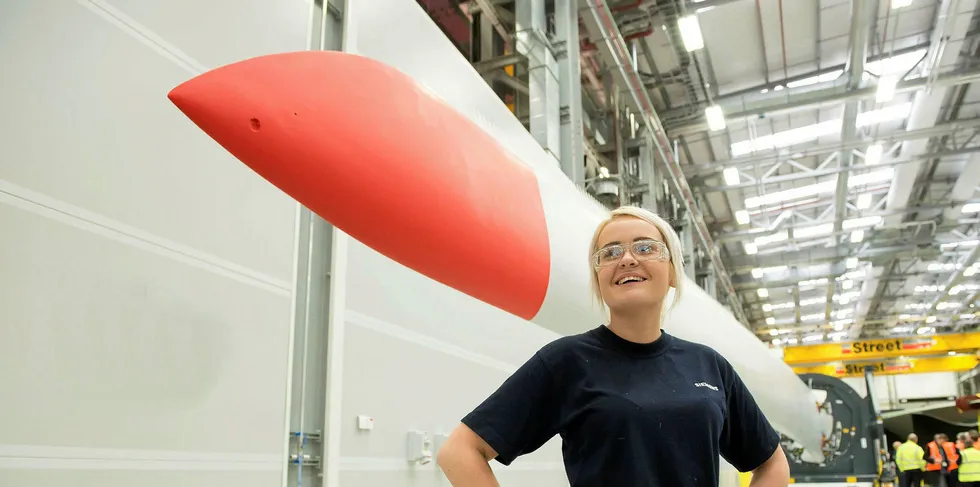A female worker with the first blade manufactured at the Siemens Gamesa factory in Hull.