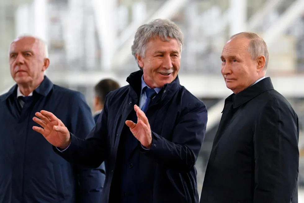 Task: Russian President Vladimir Putin (right) and Leonid Mikhelson, executive chairman of Russian gas independent Novatek (centre).