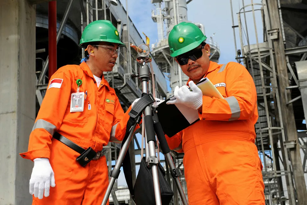Hard at work: two engineers check their notes in the process area of the Tangguh LNG plant in Indonesia