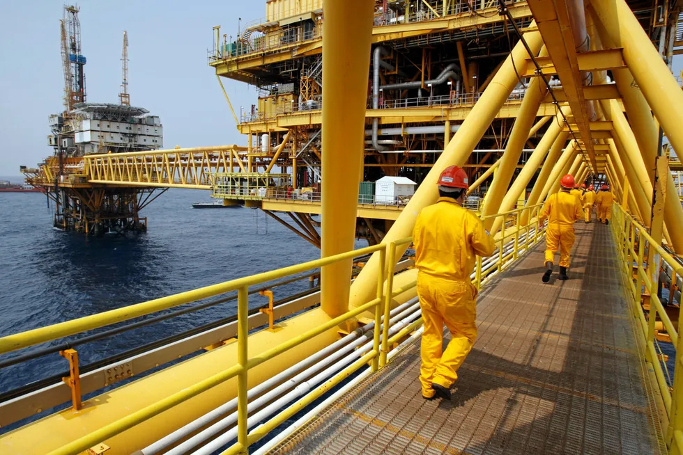 Investment: employees walk on a bridge on its way to a Pemex platform in the Ku-Maloob-Zaap field in the Bay of Campeche area offshore Mexico