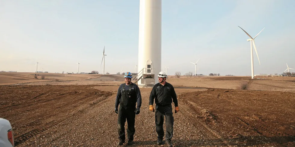 Techicians walk away from a wind turbine at a project in the US.