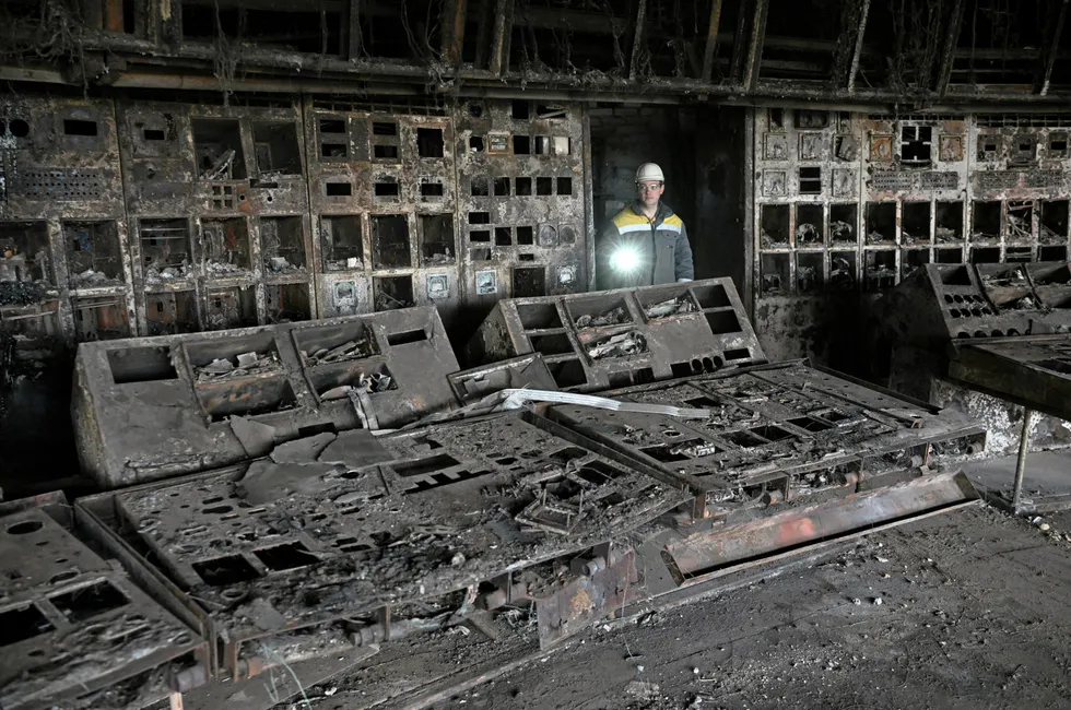 A worker walks through a burned control room of a power plant at energy supplier DTEK, destroyed after an attack, at an undisclosed location in Ukraine, April 19, 2024.