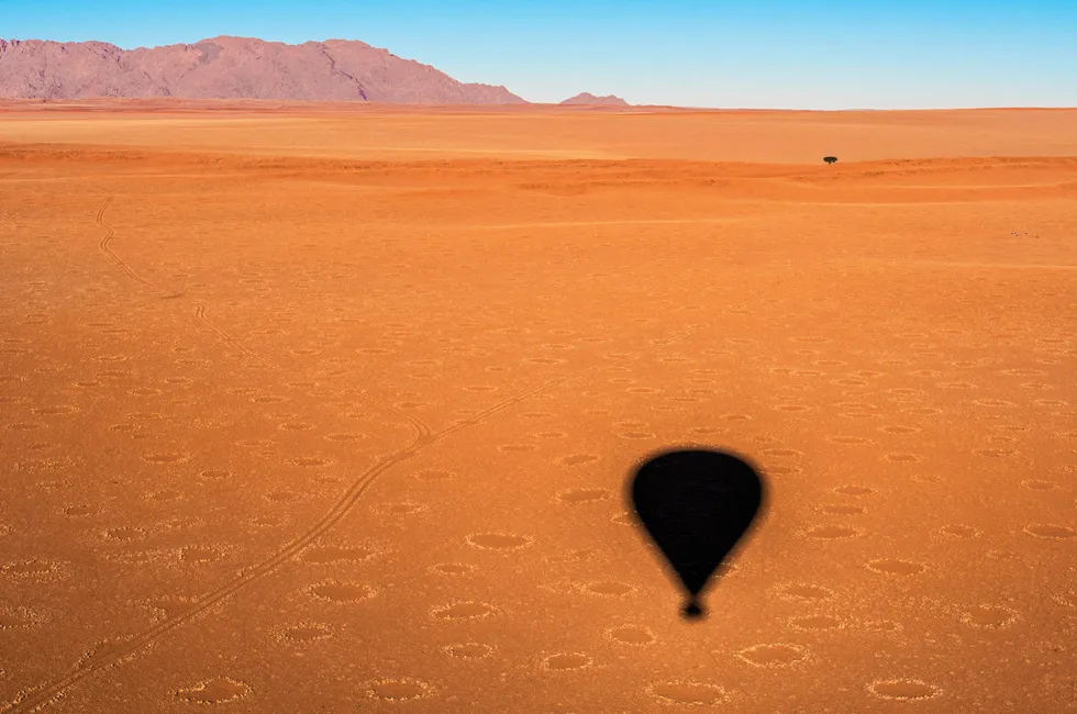 Natural formations known as fairy circles, which indicate the presence of underground natural hydrogen, seen from a hot-air balloon in the Namib Desert, Namibia.
