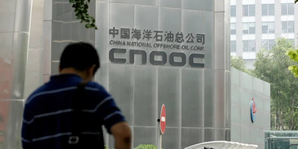 A man stands outside the headquarters building of China National Offshore Oil Corporation (CNOOC) in Beijing.