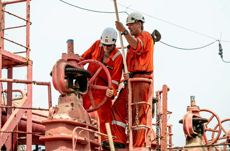 Rescue mission: Workers begin pumping oil from the FSO Safer to a replacement tanker off the coast of Yemen.