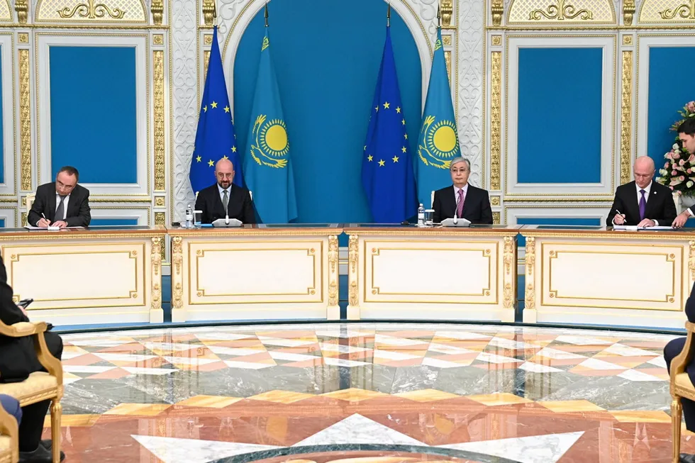 European Council president Charles Michel, second left, and Kazakh president Kassym-Jomart Tokayev, ait impassively as Svevind CEO Wolfgang Kropp, far left, and Kazakh first deputy prime minister Roman Skylar, sign the agreement at the presidential palace in Astana.