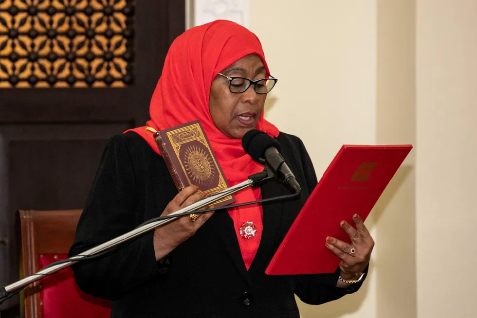 New head of state: Tanzanian President Samia Suluhu Hassan holds the Koran during the swearing-in ceremony in Dar es Salaam on 19 March, 2021.