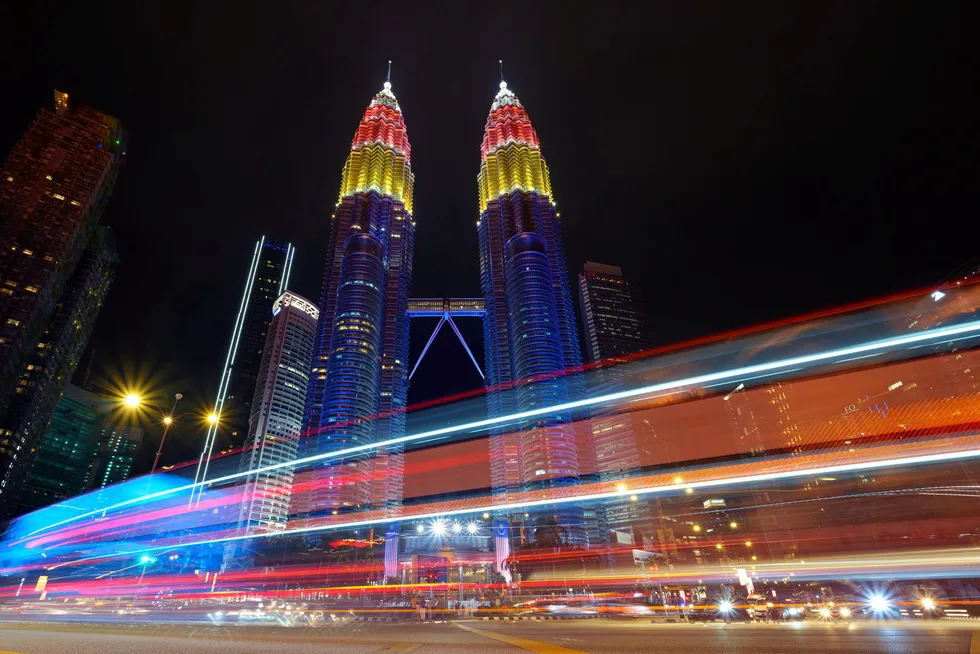 Illuminated: the Petronas Twin towers decorated with coloured lights during the 64th National Day celebrations in August 2021.