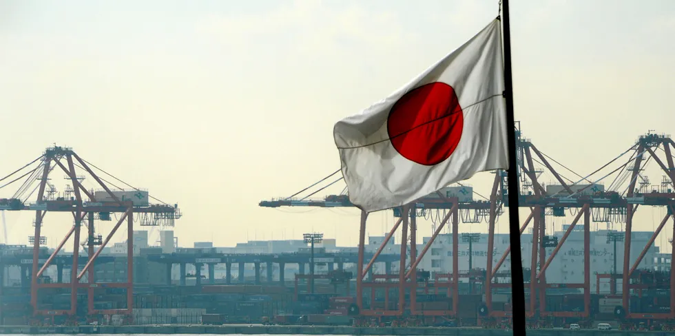 The Japanese national flag flies in front of the container pier in Tokyo port. KITAMURA (Photo credit should read TOSHIFUMI KITAMURA/AFP/Getty Images) . Japan.